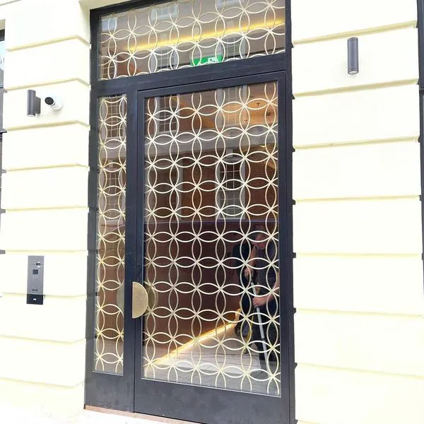 Decorative brass fretwork panels on doors in Pimlico, London